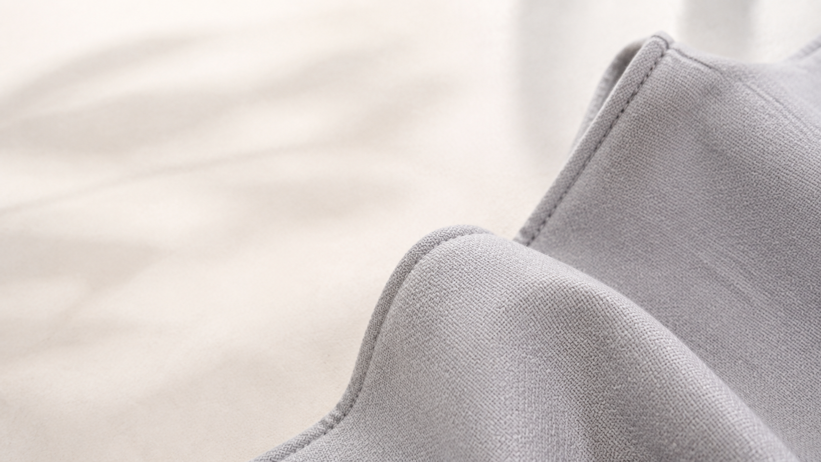 Close editorial detail of Bibzy's light grey woven carrier fabric