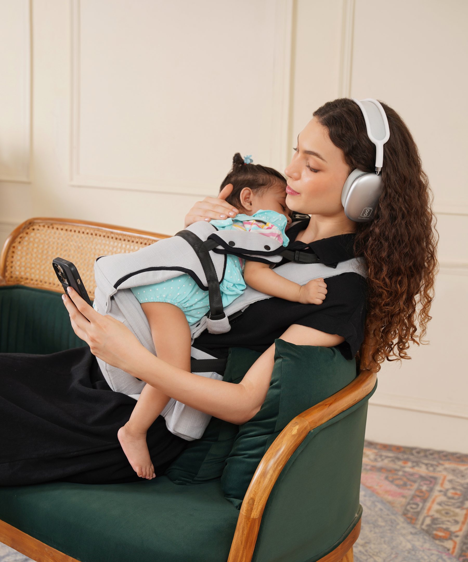Parent relaxing closely with baby in Bibzy carrier